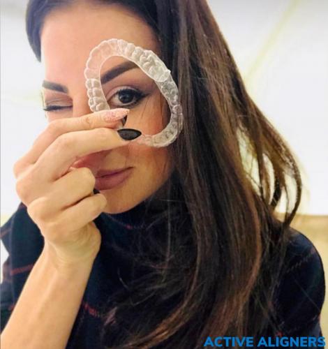 Girl holding Active Aligners